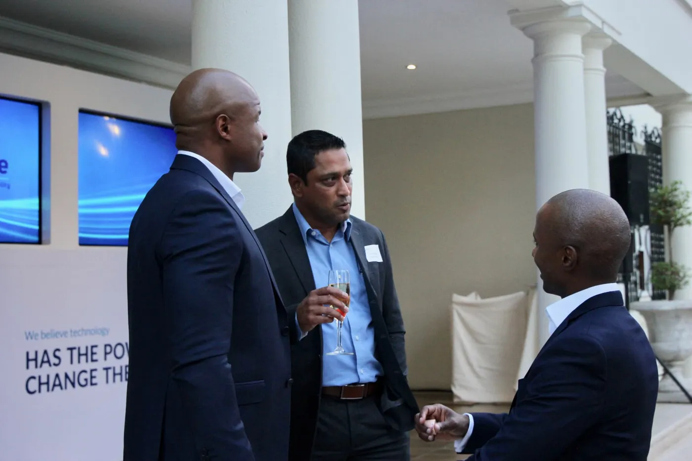 Guests in conversation beside the launch wall